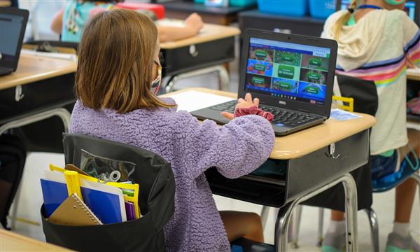 student works on laptop